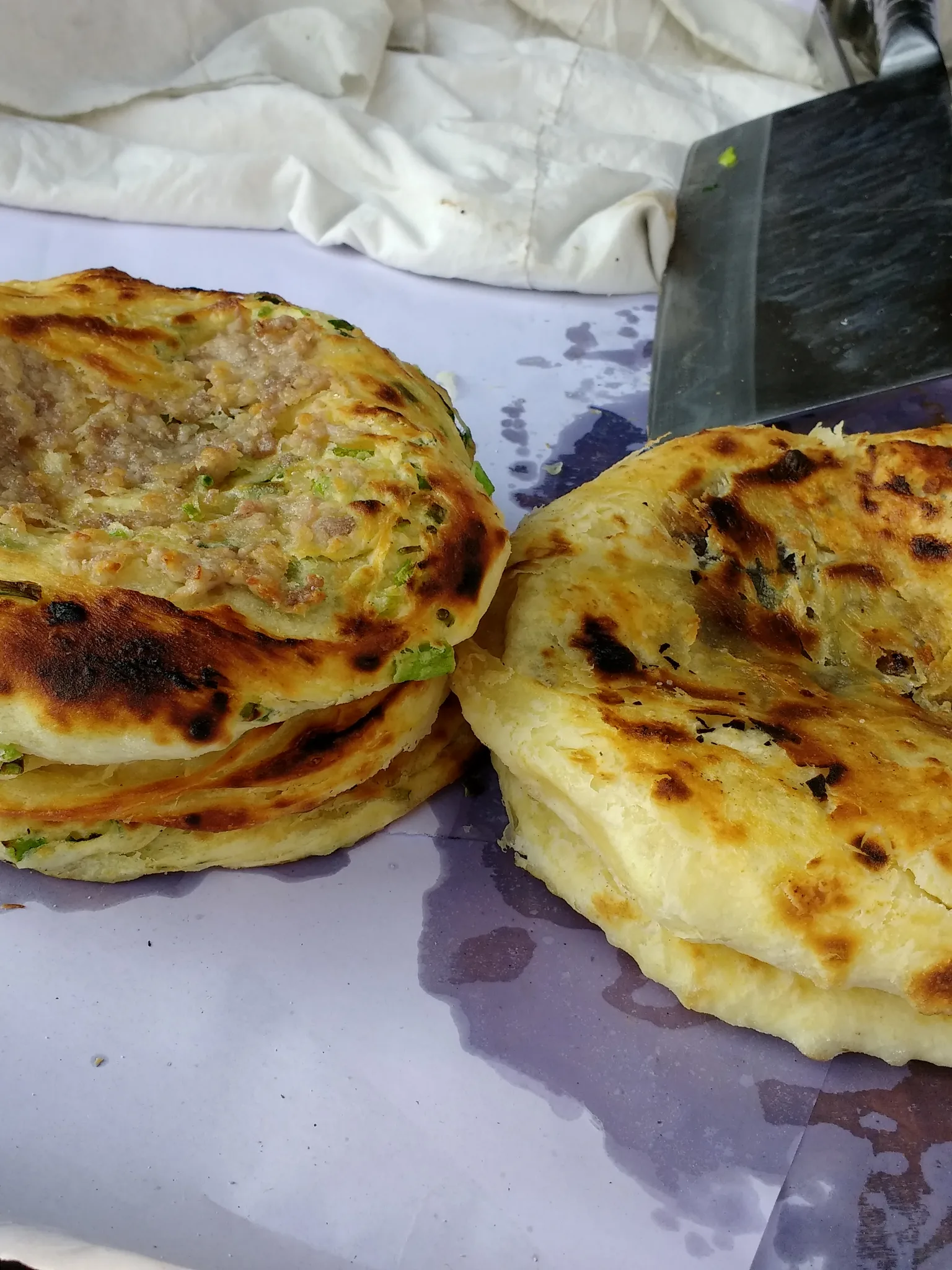 Baba: Baba (粑粑), a kind of bread from southwest China. The baba pictured has meat and was for sale in Xizhou (喜洲), Dali, China