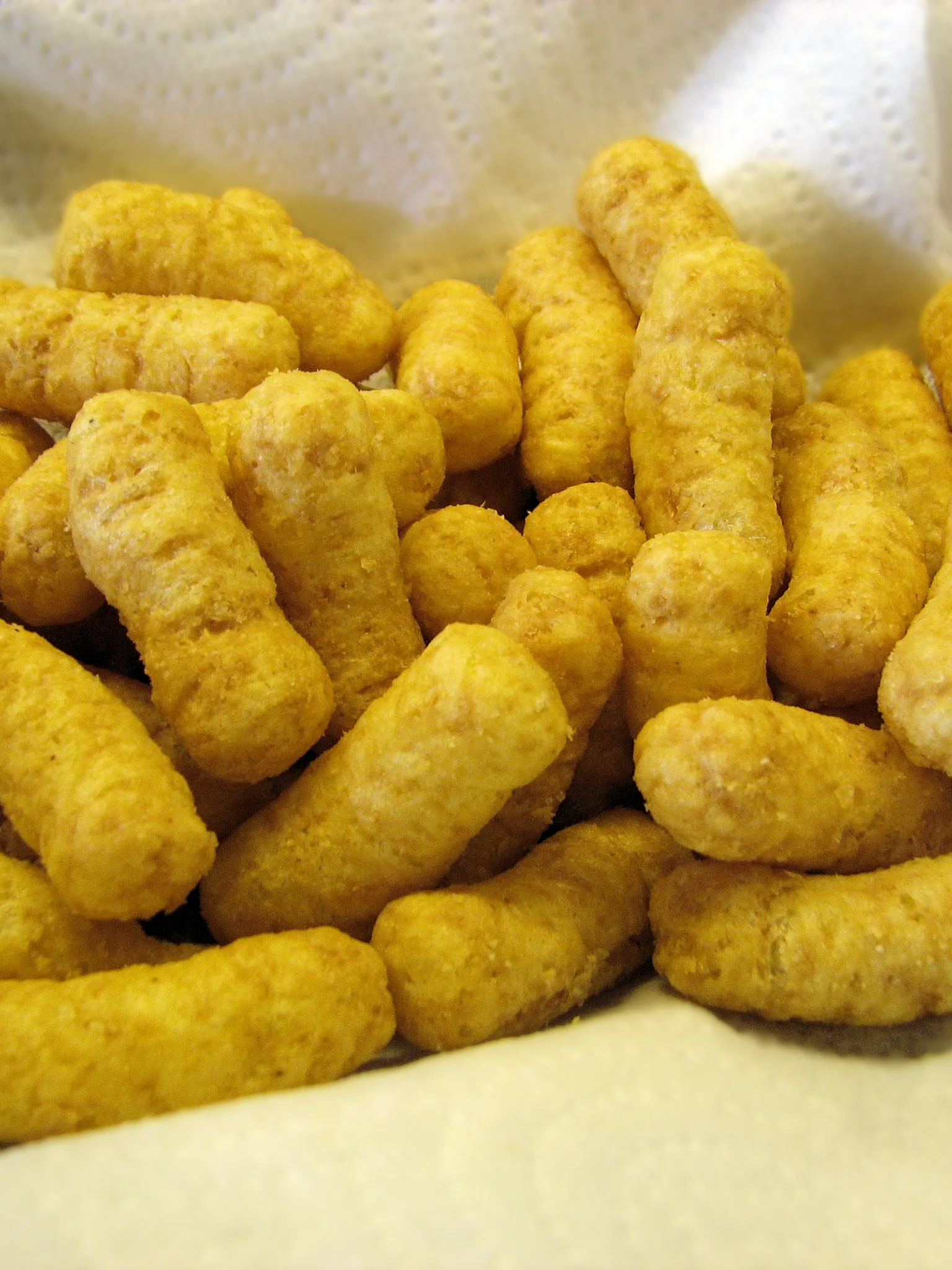 Bamba: Close-up of Bamba snack, to illustrate texture, colour and shape. Bamba is an Israeli snack composed of puffed cornmeal and flavored like peanut butter. It is a Kosher food product