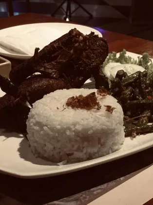 betutu: A photograph of a Duck dish, known as Bebek Betutu, served with rice and green beans