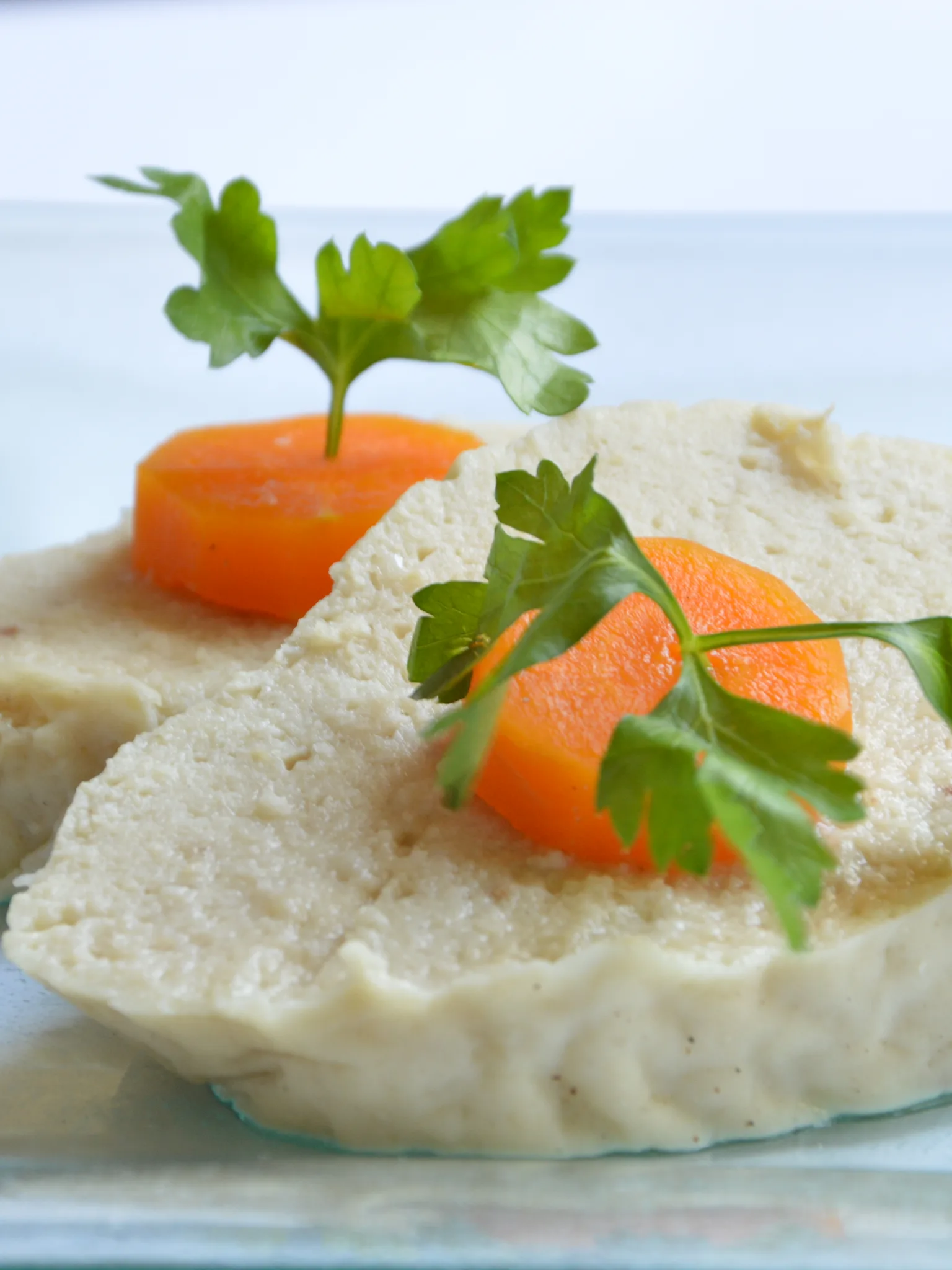 gefilte fish: Gefilte fish topped with slices of carrot