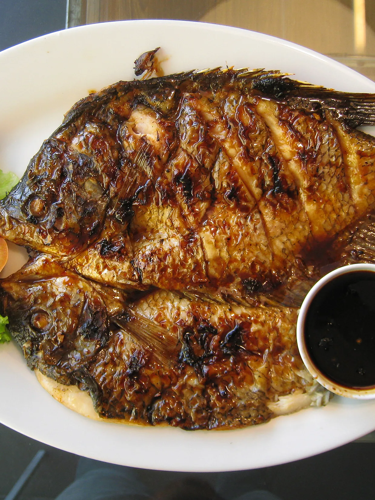 Ikan bakar: Gurame bakar kecap, barbecued gourami fish seasoned with sweet soy sauce. Popular Indonesian dish, served in D'Cost restaurant in Jakarta, Indonesia