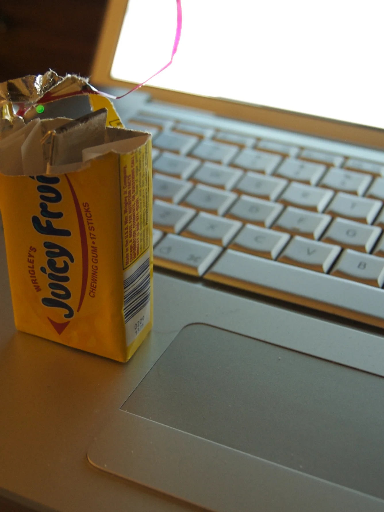 Juicy Fruit: Half a pack of chewing gum (Juicy Fruit), placed on a laptop computer (MacBook Pro)
