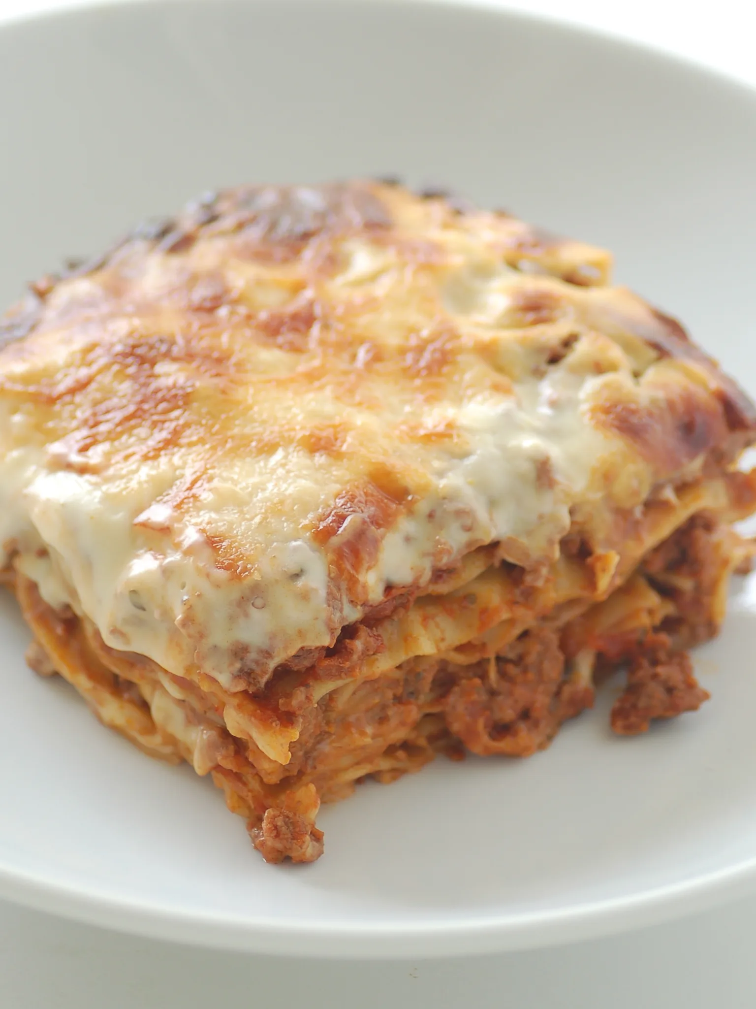 lasagna: Lasagne served on a white plate