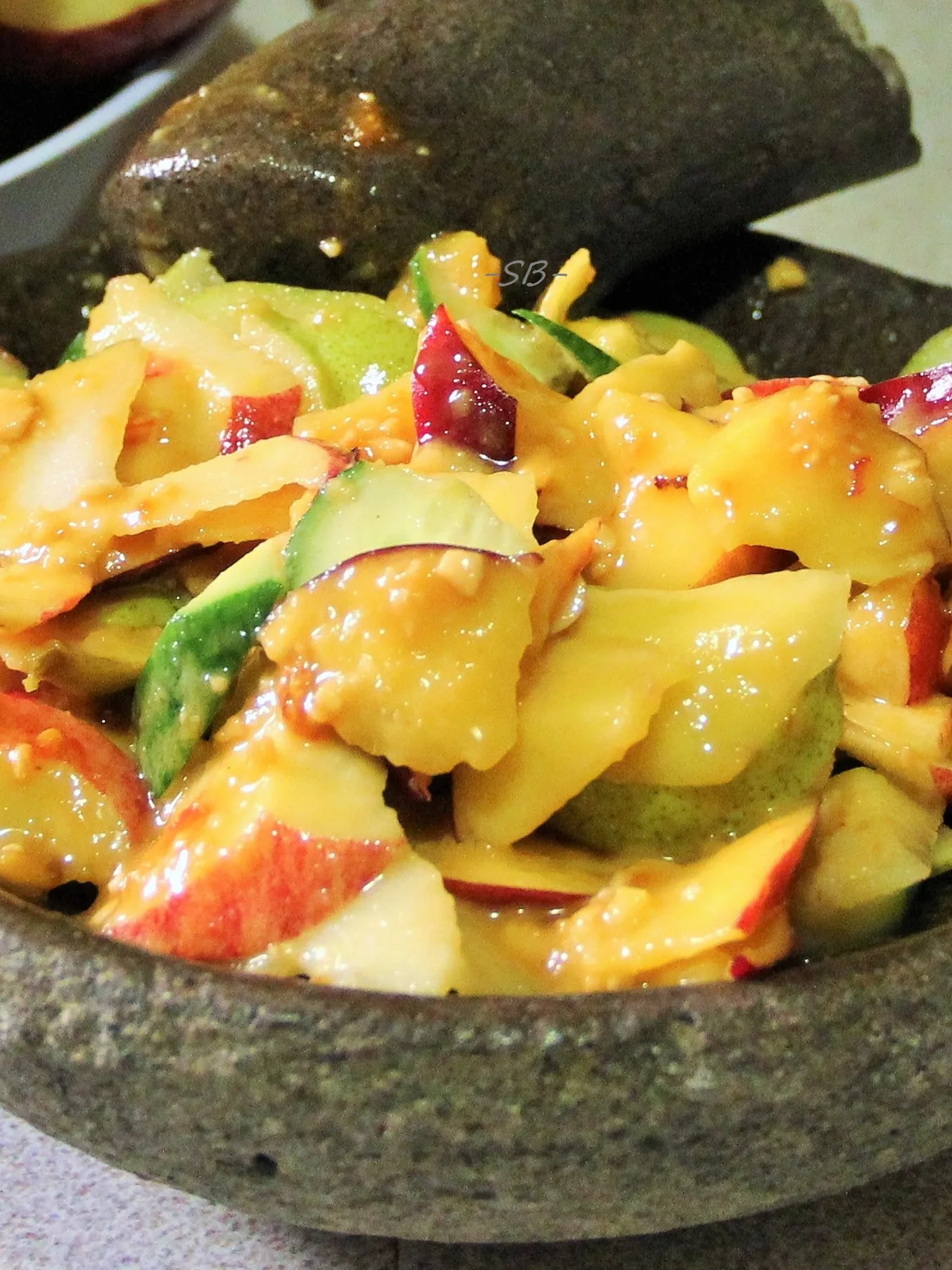 rojak: Rujak Buah is an Indonesian Fruit Salad. It is made of a mixture of fruits and spicy peanut sauce. Pestle and mortar sets are commonly used to make the sauce and to toss the mixture