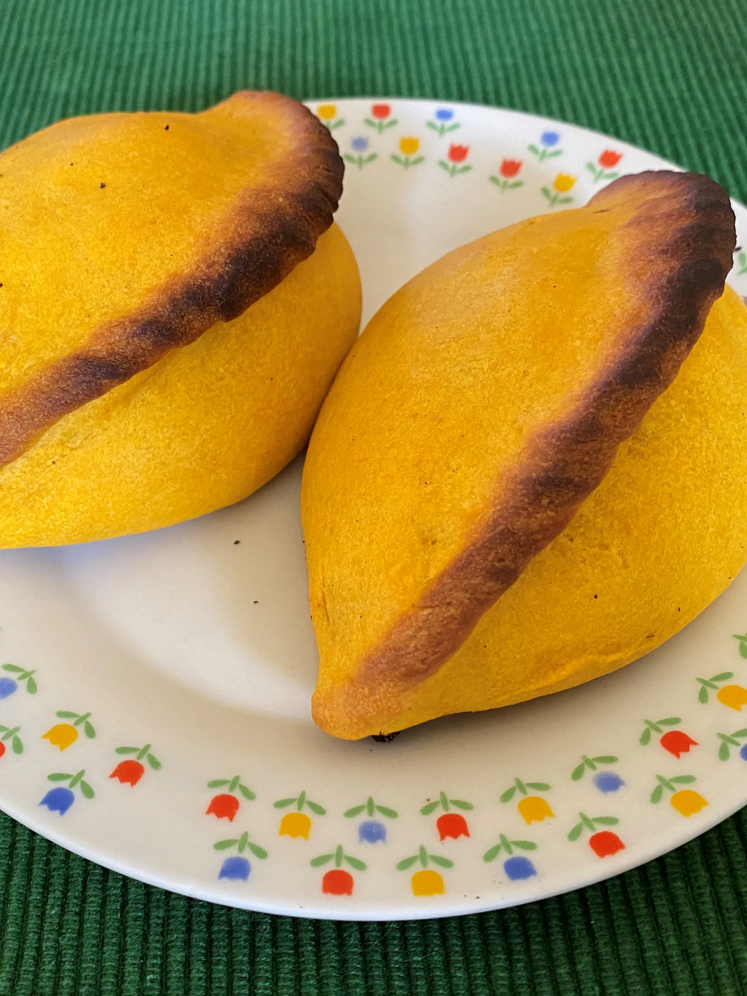 salteña: Salteñas, a Bolivian empanada filled with beef or chicken, mixed in a sweet, lightly spicy sauce and containing chopped potatoes, raisins and hard eggs